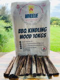 A burlap sack labelled 'BBQ Kindling Wood 10kg' from Wheelie Hot Wood filled with firewood pieces, displayed outdoors.  Wheelie Hot Wood delivers firewood in a wheelie bin in Northern Rivers NSW and Gold Coast, QLD. Bags of Firewood are also available for retail stores. 