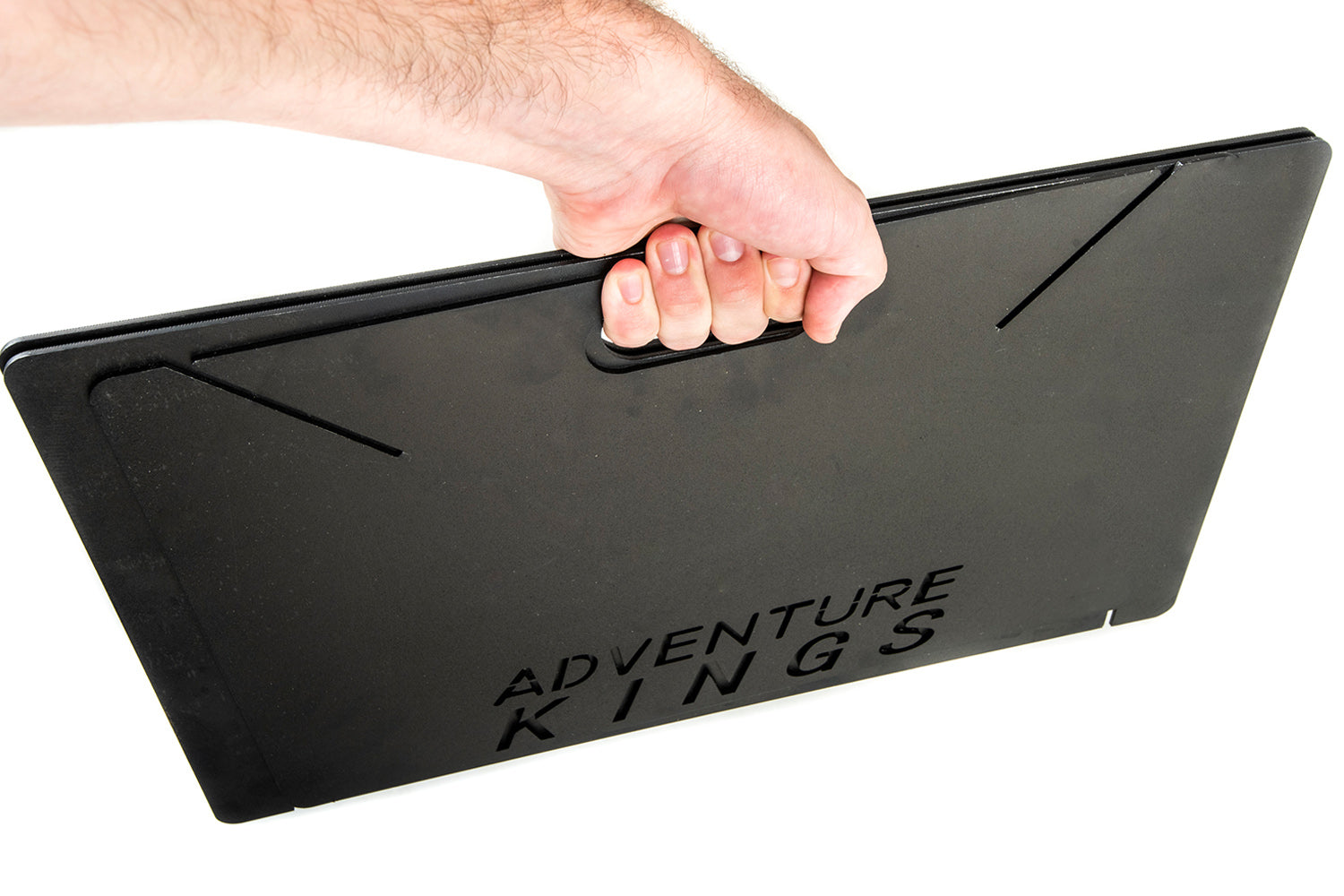 image showing the Adventure Kings Portable Steel Firepit collapsed down flat and being held off the ground in someone's hand