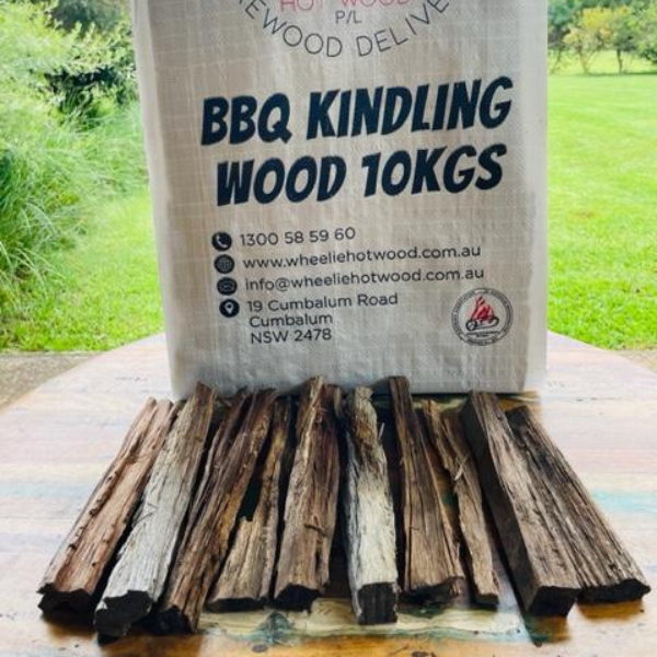 Bag of BBQ kindling wood with kindling in front on a wooden surface