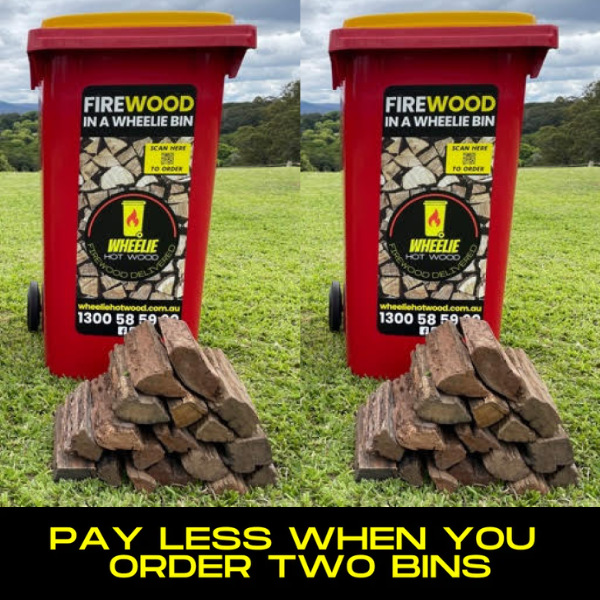 Two red wheelie bins labelled 'Firewood in a Wheelie Bin' with stacked firewood on a grassy field. each bin has a small pile of Double Split Firewood in front of it. the bottom section of the image has a black background and the words "pay less when you order two bins" in large yellow font.