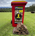pile of double split firewood in front of red Wheelie Hot Wood bin with yellow lid on a grassy hill. the label on the bin says Firewood in a wheelie bin. Available in Northern Rivers NSW and Gold Coast, QLD.